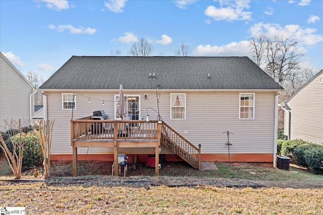 back of house with central air condition unit and a wooden deck