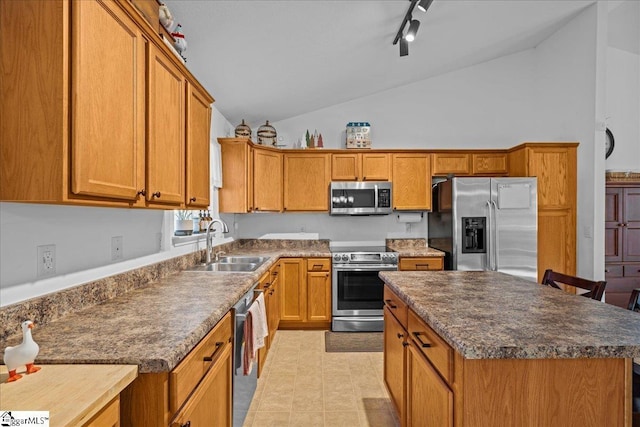 kitchen featuring track lighting, stainless steel appliances, sink, high vaulted ceiling, and a kitchen island