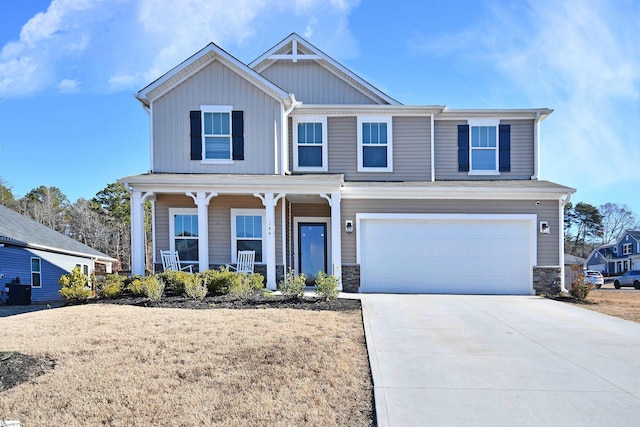 view of front of property with central AC, a front lawn, covered porch, and a garage