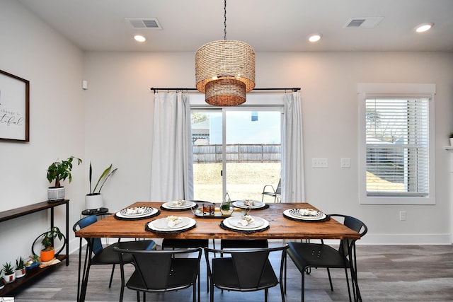 dining room featuring dark wood-type flooring and a healthy amount of sunlight