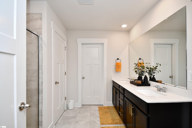 bathroom with tile patterned flooring, vanity, and walk in shower