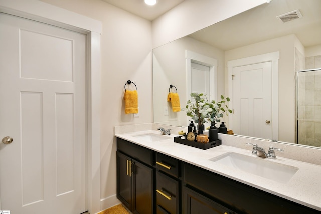 bathroom featuring vanity and a shower with shower door