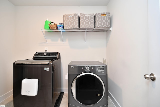 clothes washing area featuring separate washer and dryer