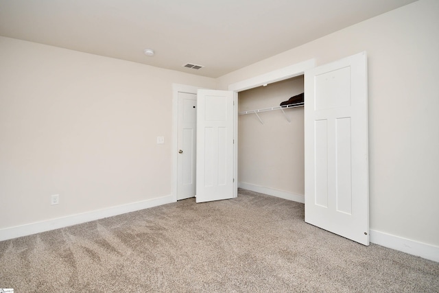 unfurnished bedroom featuring carpet floors and a closet