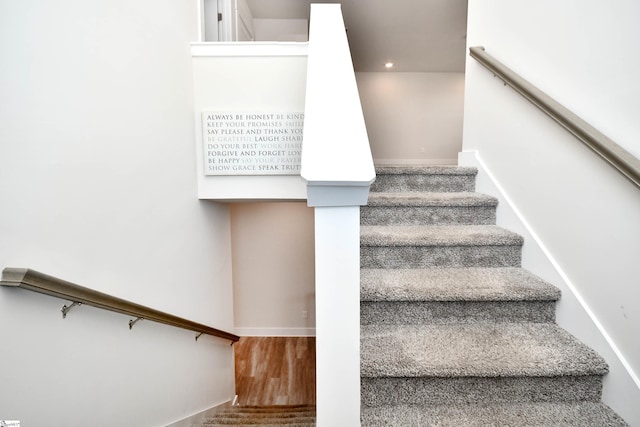 staircase featuring hardwood / wood-style flooring