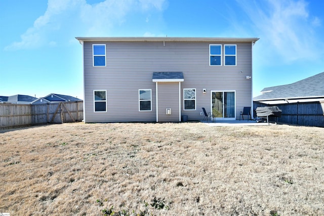 back of house featuring a yard and a patio