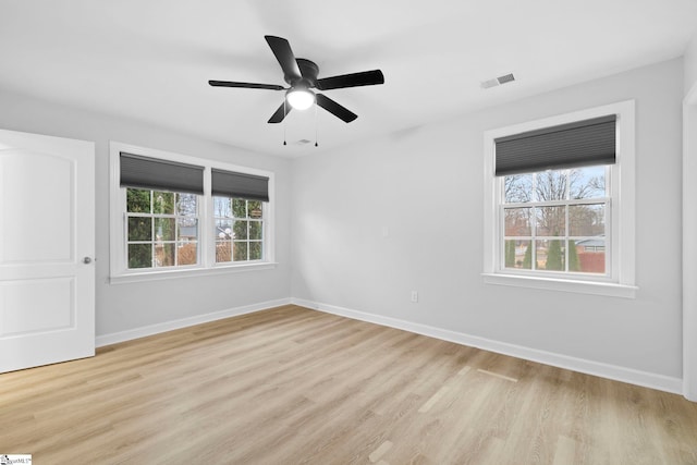 unfurnished room with light wood-type flooring and ceiling fan