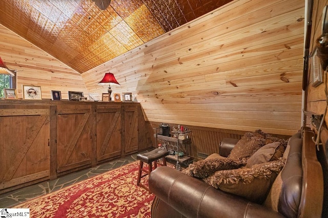 sitting room with wooden walls and lofted ceiling