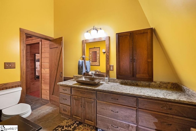 bathroom featuring tile patterned flooring, vanity, and toilet