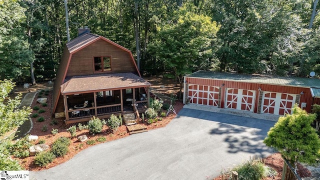 view of front of property with covered porch and an outdoor structure