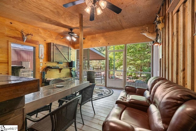 sunroom / solarium with ceiling fan and wood ceiling