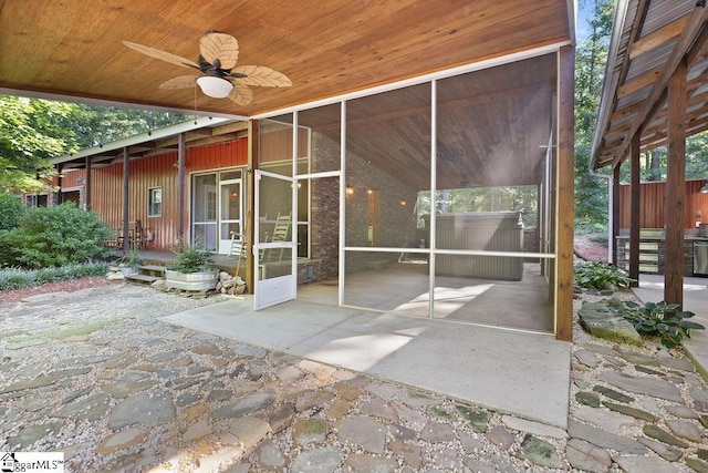 view of patio featuring a sunroom and ceiling fan