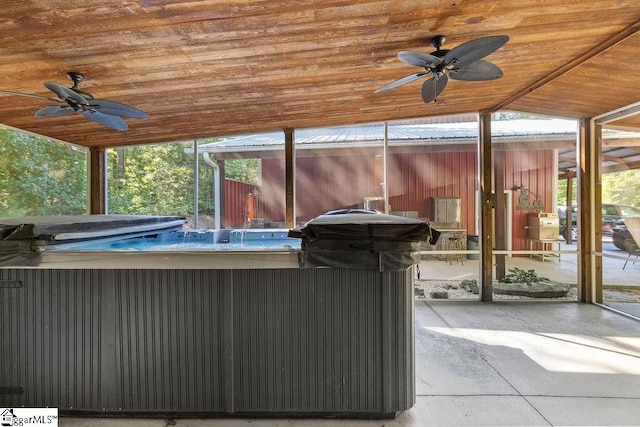 view of patio with ceiling fan and a hot tub