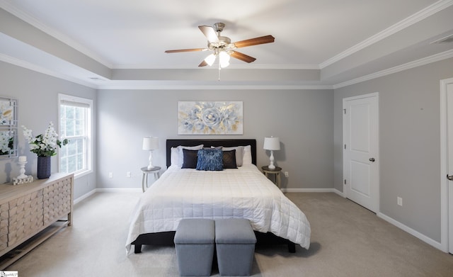 carpeted bedroom with ceiling fan, a raised ceiling, and ornamental molding