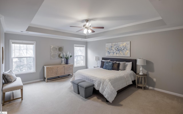 bedroom with ceiling fan, a raised ceiling, and crown molding