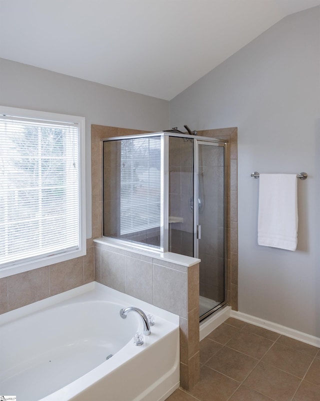 bathroom featuring separate shower and tub, tile patterned flooring, and vaulted ceiling