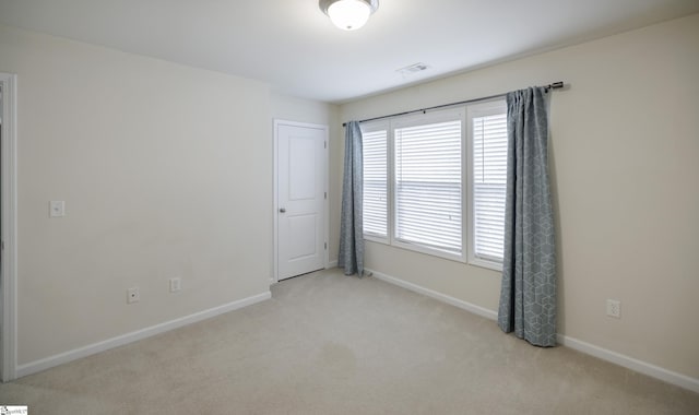 empty room with light colored carpet