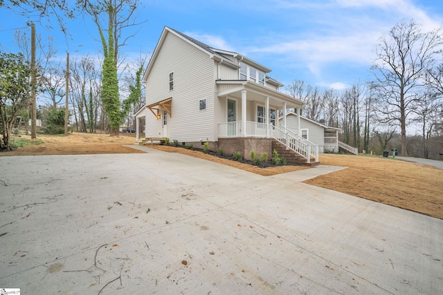 view of side of home featuring a porch