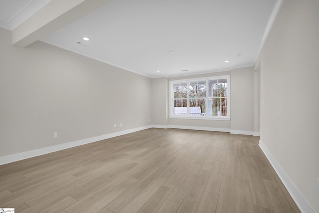 unfurnished room with light wood-type flooring and crown molding