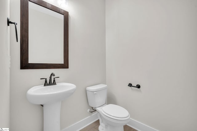 bathroom with tile patterned floors, sink, and toilet