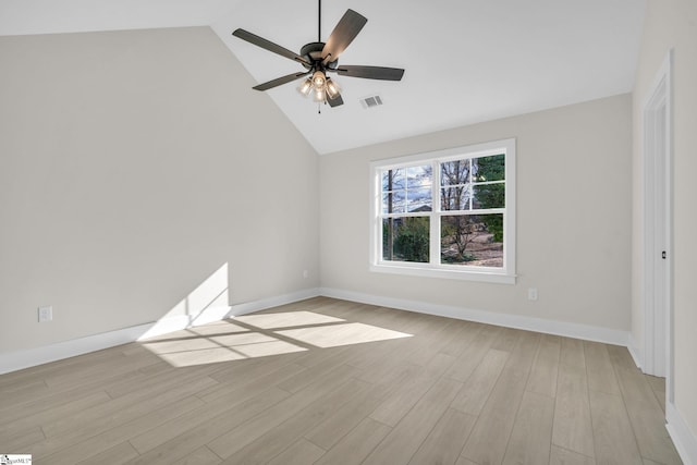 empty room featuring light hardwood / wood-style floors, vaulted ceiling, and ceiling fan