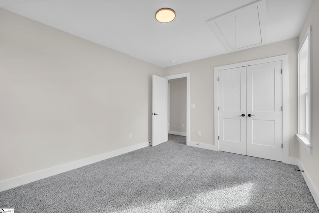 unfurnished bedroom featuring carpet and a closet