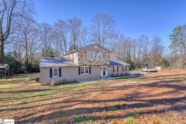 back of property featuring a lawn