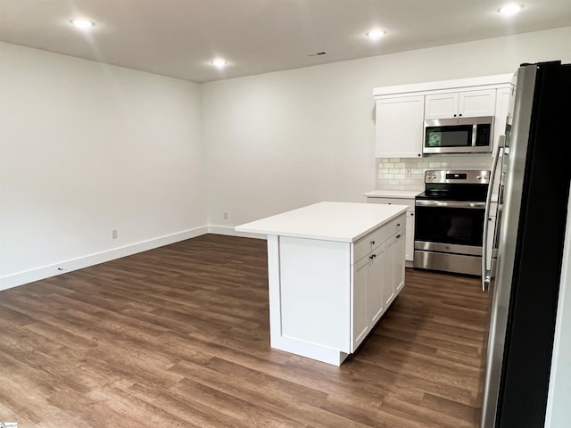 kitchen featuring a center island, white cabinets, appliances with stainless steel finishes, tasteful backsplash, and dark hardwood / wood-style flooring