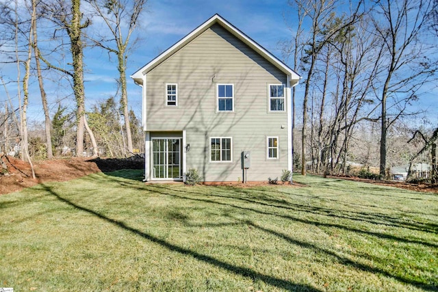 rear view of property with a lawn