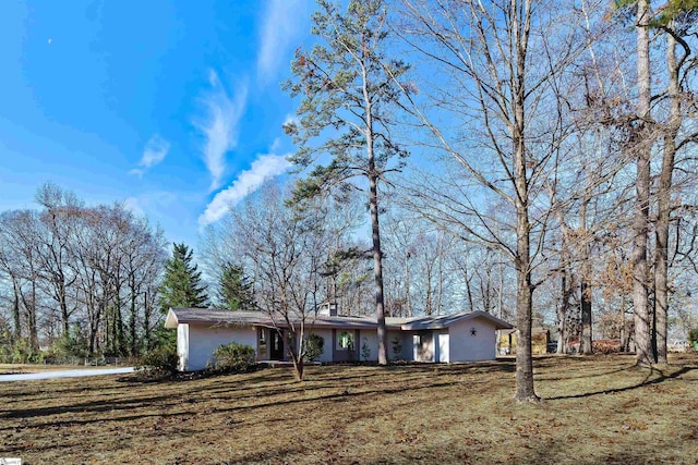 ranch-style house with a front lawn