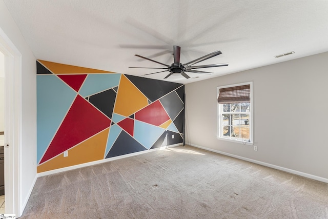 carpeted empty room featuring ceiling fan