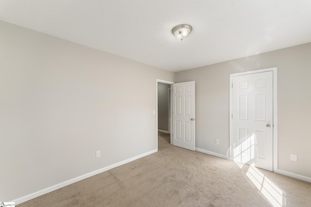 unfurnished room featuring light colored carpet