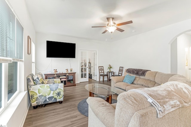 living room featuring wood-type flooring and ceiling fan