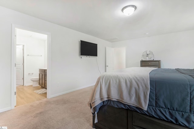 carpeted bedroom with connected bathroom