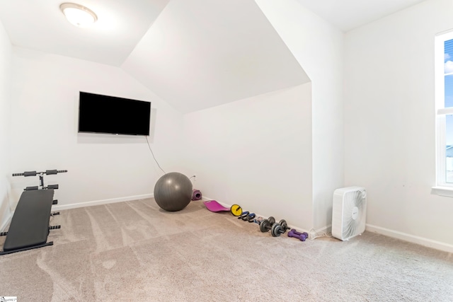 exercise room featuring carpet floors and lofted ceiling