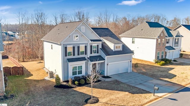 view of front of home featuring cooling unit and a garage