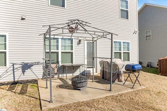 view of patio / terrace with grilling area and a fire pit