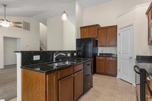 kitchen featuring dark stone counters, vaulted ceiling, ceiling fan, black appliances, and sink