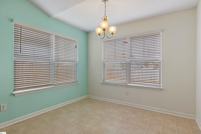 unfurnished room featuring lofted ceiling and a notable chandelier