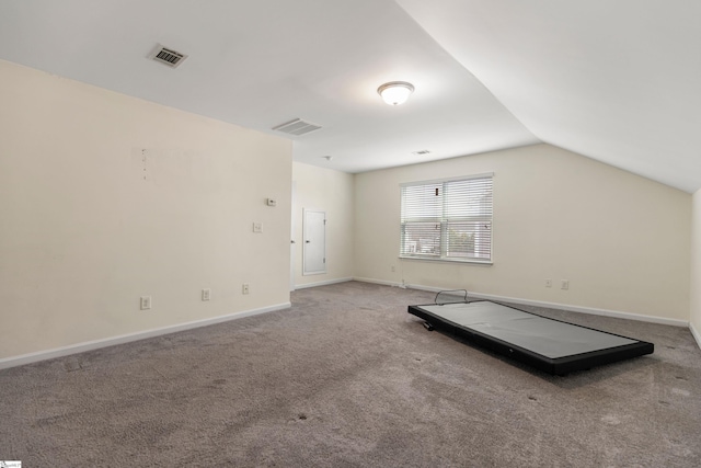 bonus room with carpet flooring and vaulted ceiling