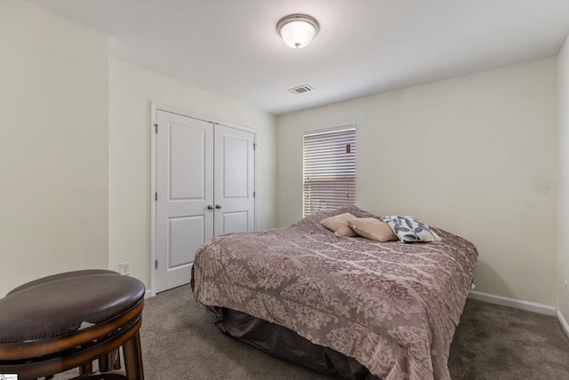 bedroom featuring dark carpet and a closet