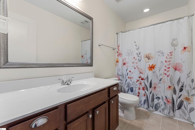 bathroom featuring tile patterned flooring, vanity, and toilet