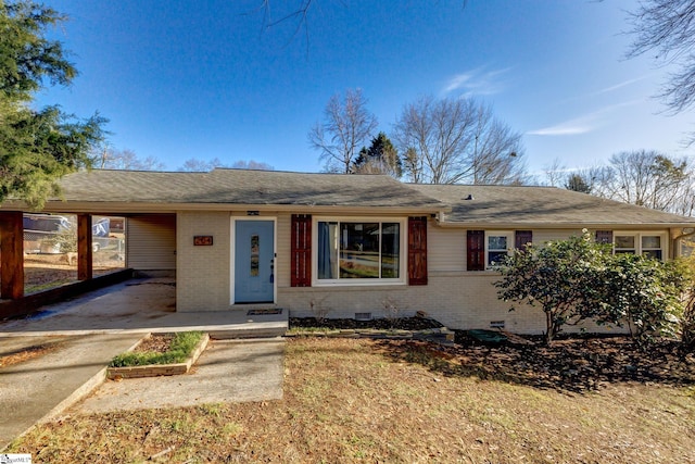 ranch-style home featuring a carport