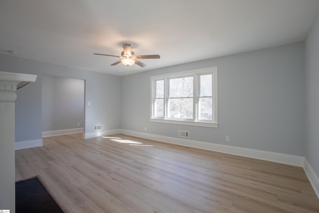 spare room featuring light wood-type flooring and ceiling fan