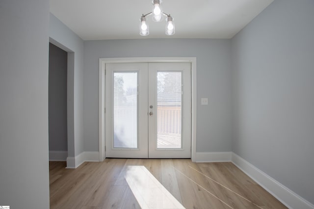 entryway with french doors and light wood-type flooring