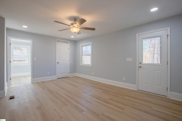 entrance foyer with ceiling fan, a healthy amount of sunlight, and light hardwood / wood-style floors