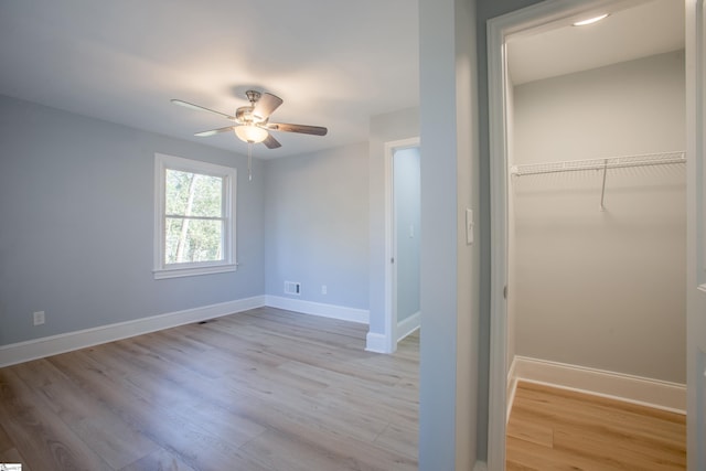 unfurnished bedroom with ceiling fan, a closet, and light wood-type flooring