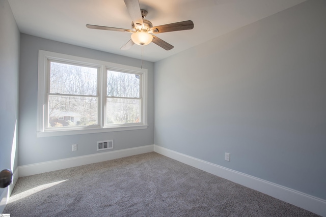 carpeted spare room with ceiling fan