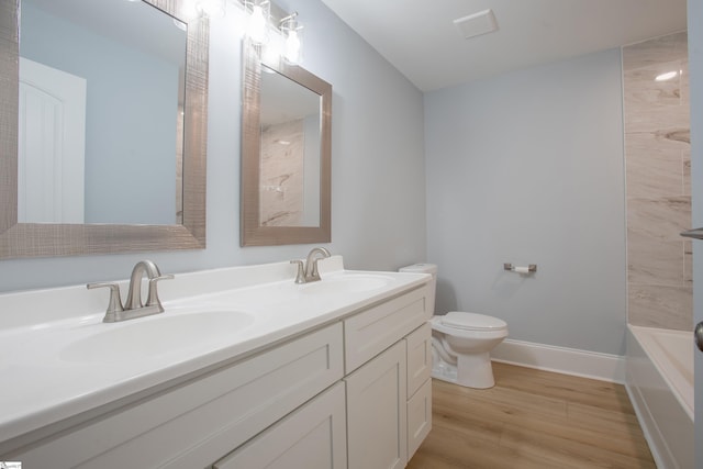 full bathroom featuring vanity, toilet, wood-type flooring, and bathtub / shower combination