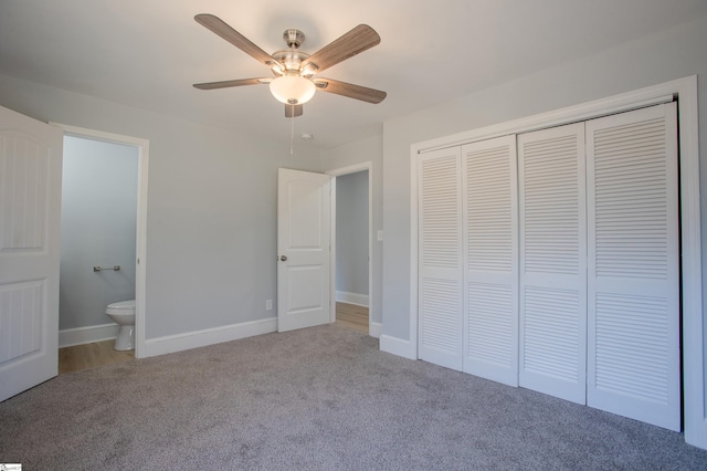 unfurnished bedroom featuring carpet, a closet, ceiling fan, and ensuite bathroom